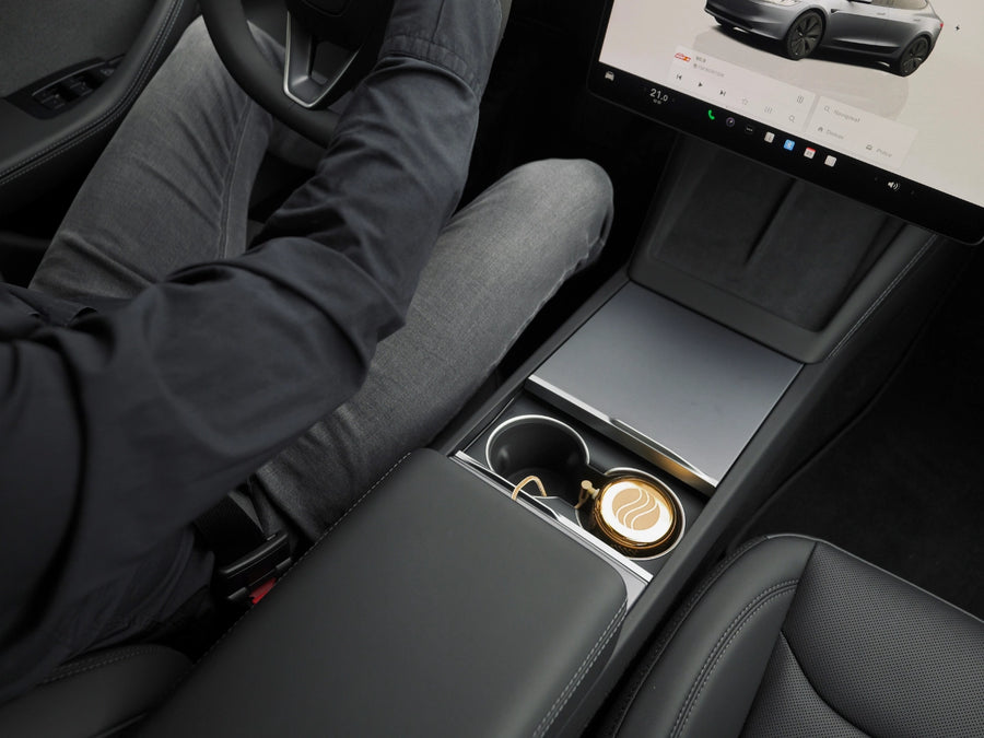 Somavedic Elaura placed in a cup holder within a modern electric vehicle interior.